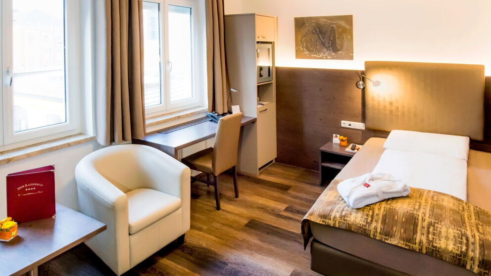 Hell beleuchtetes Zimmer im Hotel der Kaiserhof mit gemütlichen Bett und modernem Einrichtungsstil